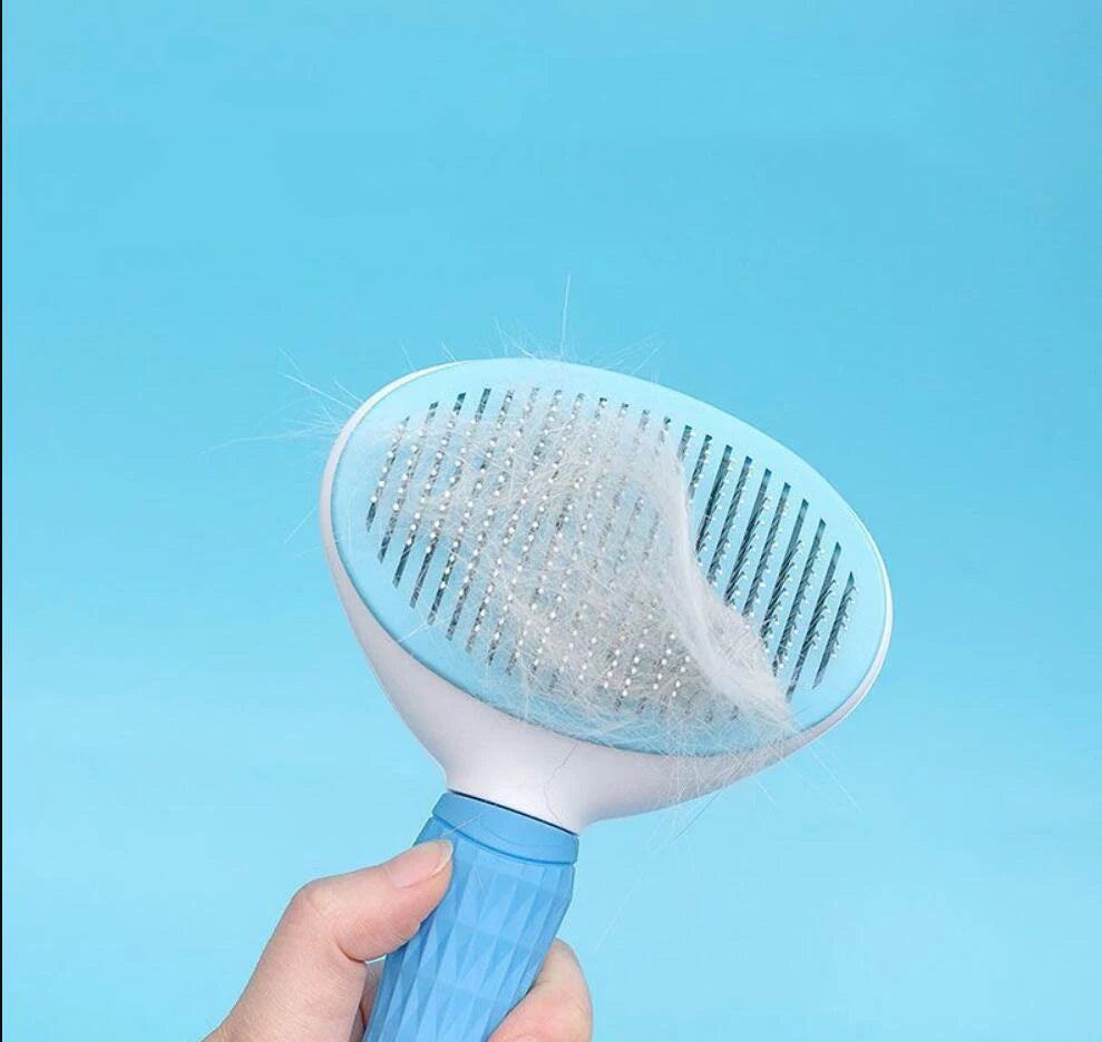 Stainless steel pet detangling comb in pink for long-haired dogs and cats